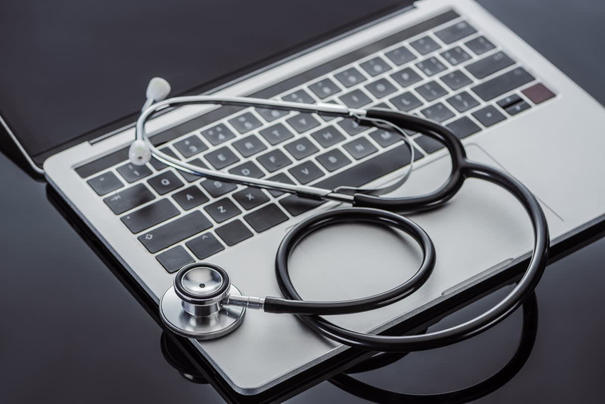 stethoscope on top of laptop