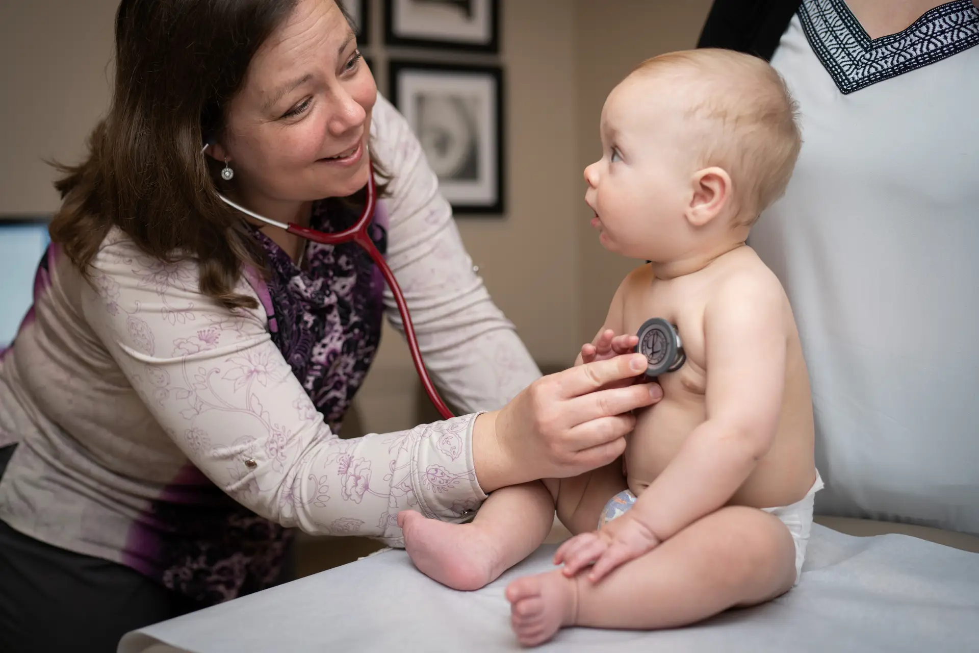 Doctor listening to heartbeat of baby